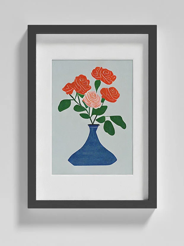 An image of a Matisse style roses in a jar print in a frame on a wall